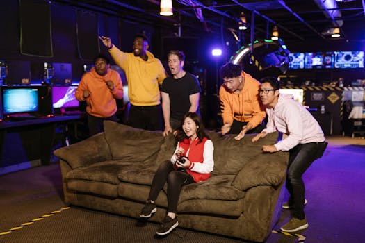 A diverse group of friends gaming indoors, sharing excitement and fun during video game play on a cozy couch.