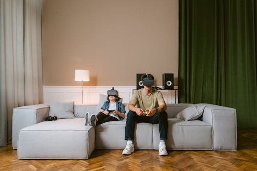 A man and child enjoying video games with VR headsets on a modern couch at home.